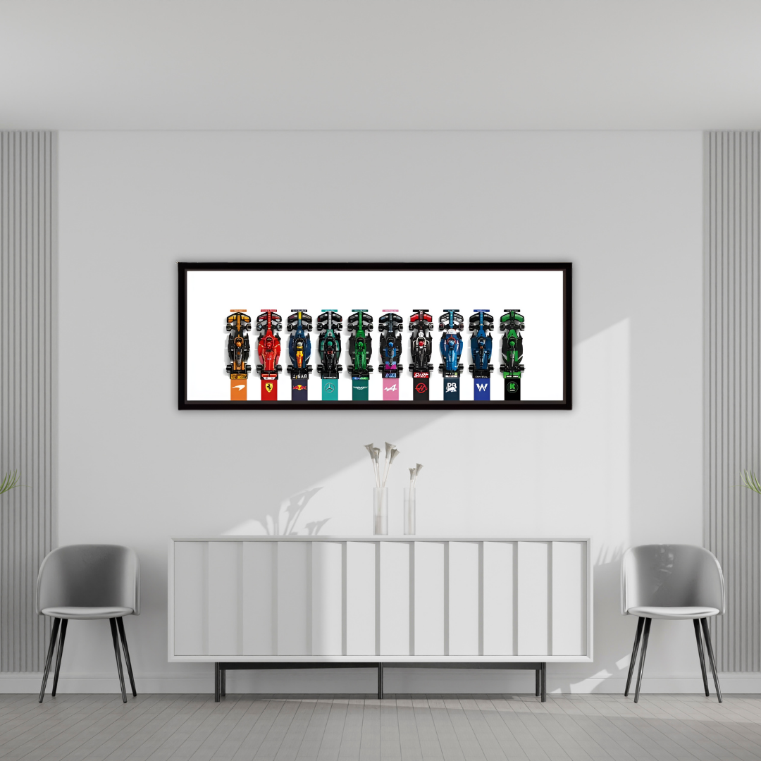 Framed artwork of colorful shoes on a wall in a modern room with gray chairs and a white console table.
