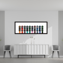 Framed artwork of colorful shoes on a wall in a modern room with gray chairs and a white console table.