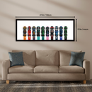 Wall art with colorful car models displayed above a beige sofa.